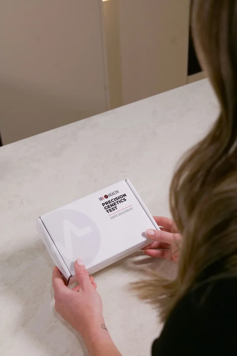 A person holding a 10X Precision Genetics test box